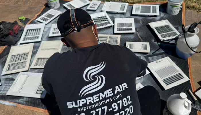 technician cleaning air duct grills